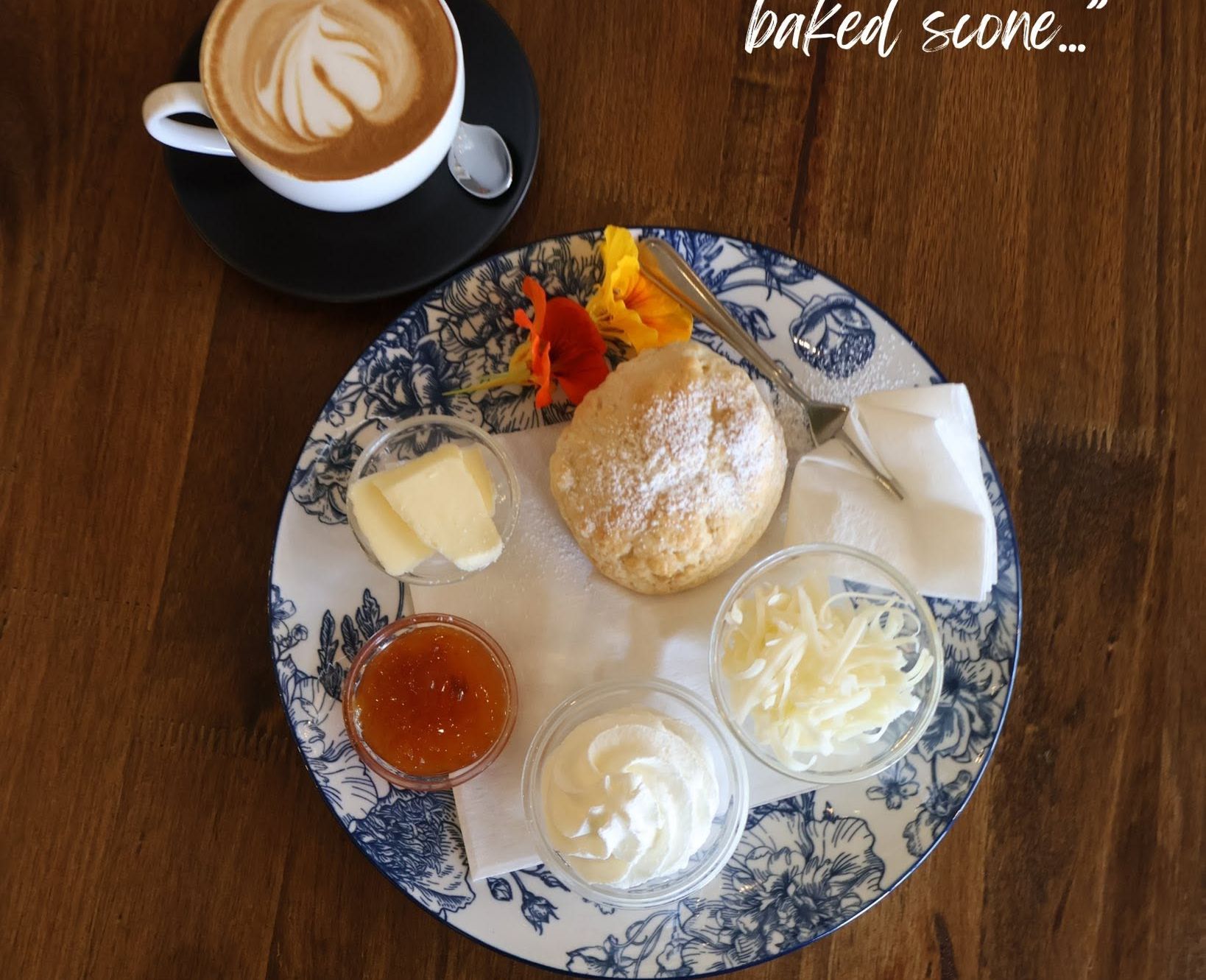 Freshly baked scone with jam and cream
